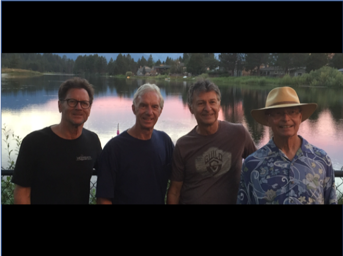 The four members of ditchweed harvest by a lake