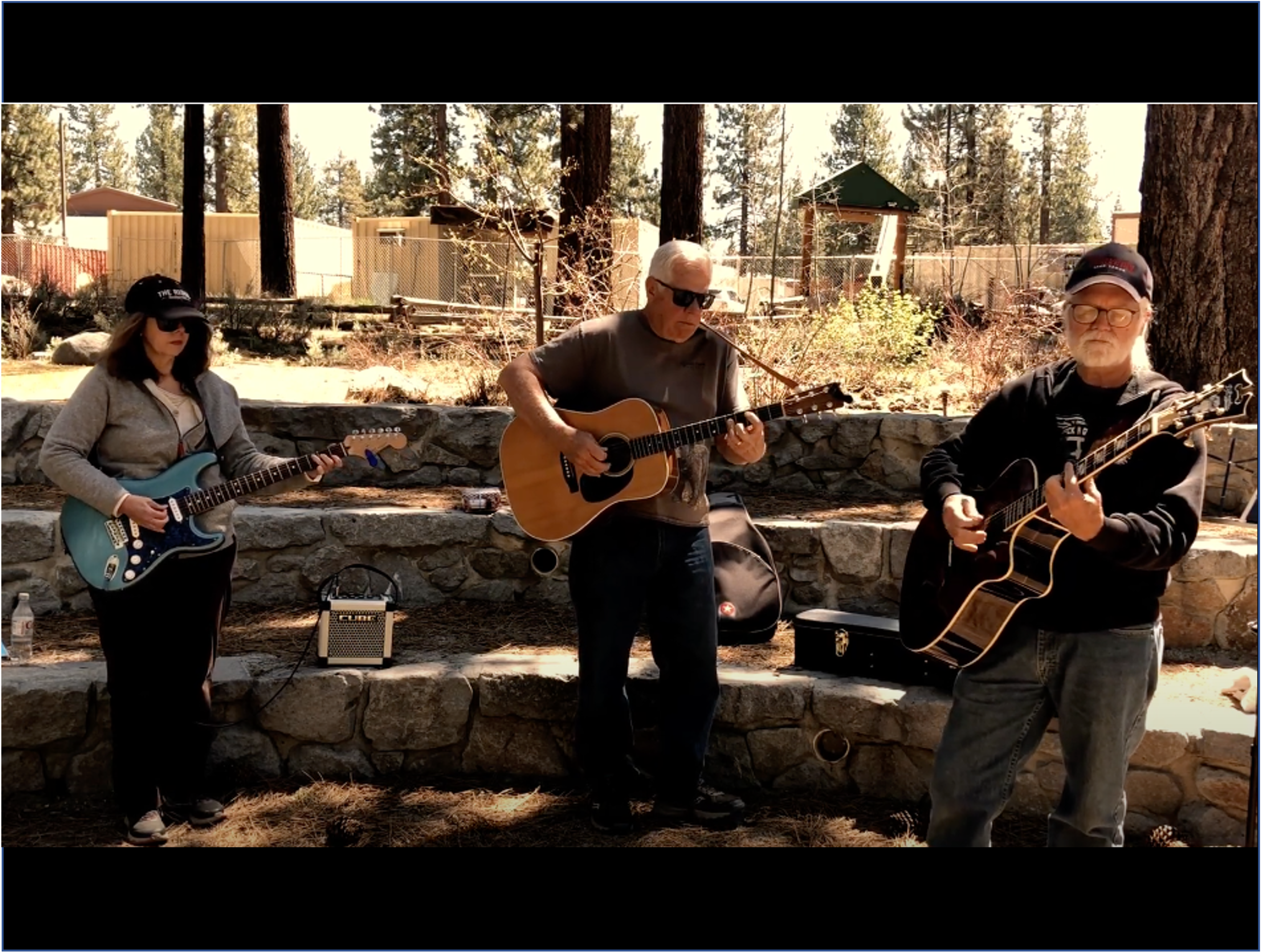 Three people playing guitar